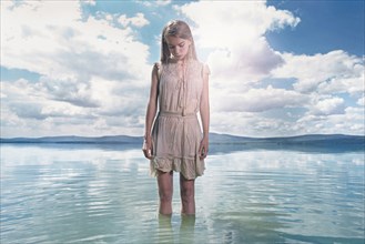 Caucasian girl standing in lake