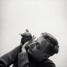 Caucasian man playing with hairless cat on shoulder