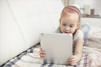Caucasian girl using digital tablet