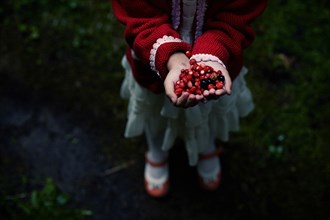Caucasian girl gathering berries