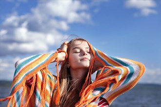 Caucasian teenage girl smiling with shawl