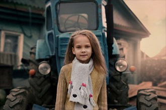 Caucasian girl standing near tractor