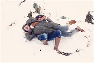 Caucasian teenage girls playing in snow