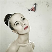 Caucasian woman admiring butterfly
