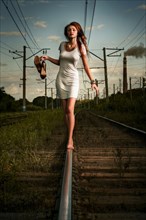 Caucasian woman balancing on train tracks