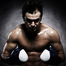 Caucasian boxer flexing his muscles