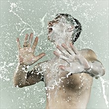Caucasian man splashing in milk