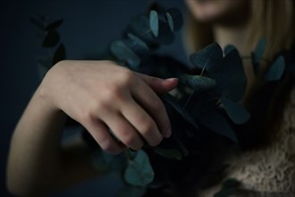 Caucasian teenage girl holding plants