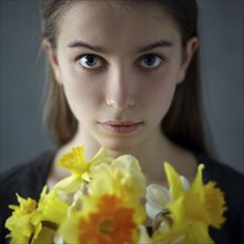 Caucasian girl holding yellow flowers