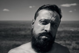Caucasian man with beard in field