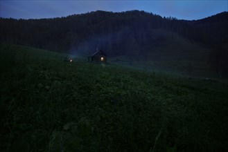 Distant house on hill at night