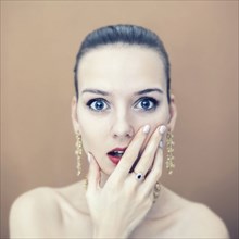 Portrait of surprised Caucasian woman wearing earrings