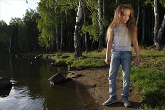 Caucasian girl standing near river