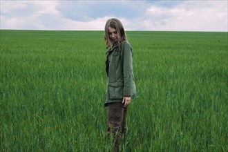 Caucasian woman standing in grass field