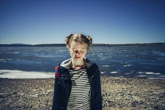 Caucasian teenage girl standing on sunny beach