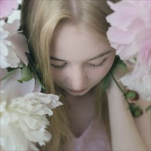 Close up of Caucasian teenage girl holding flowers