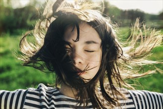 Wind blowing hair of Caucasian teenage girl