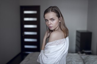 Portrait of serious Caucasian woman in bedroom