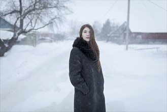 Caucasian woman wearing coat in winter