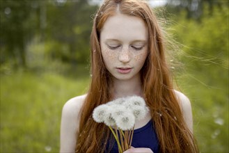 Caucasian girl with dandelion seeds hair