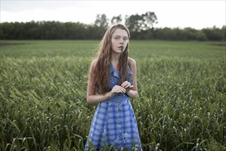 Portrait of Caucasian woman standing in field on farm