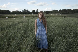 Portrait of Caucasian woman standing in field on farm