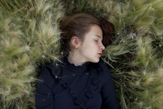 Caucasian girl laying in field