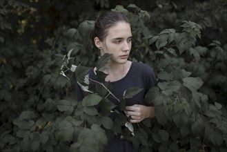 Caucasian teenage girl standing in leaves