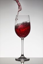 Red wine filling wine glass