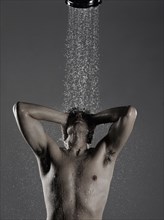 Caucasian man standing in shower