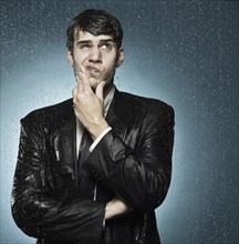 Caucasian businessman caught in the rain