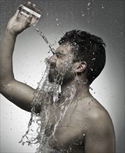 Man pouring water on himself