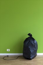 Garbage bag with plug and outlet