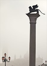 Silhouette of statue on pillar