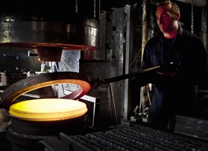 Caucasian worker melting steel in factory