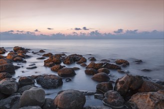Blurred ocean washing over rocks