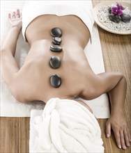 Caucasian woman enjoying hot stone massage