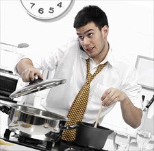 Caucasian businessman cooking in kitchen