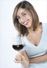 Smiling woman having glass of wine