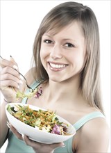 Hispanic woman eating salad