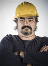 Construction worker standing with arms crossed