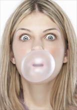 Woman blowing bubble gum bubble