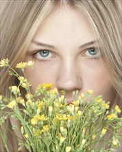 Woman smelling bouquet of flowers