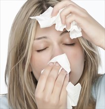 Woman wiping her nose with tissue