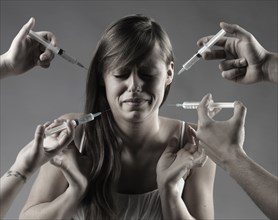 Caucasian woman fearing syringes