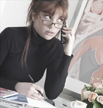 Caucasian businesswoman talking on telephone