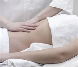 Caucasian woman receiving massage of midsection