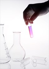 Caucasian scientist holding purple liquid in test tube