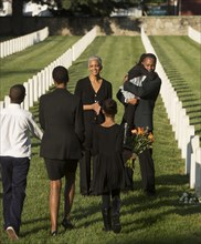 Multi-generation Black family at military cemetery