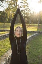Caucasian woman practicing yoga in park